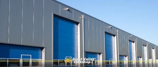 A row of blue garage doors on a commercial facility.
