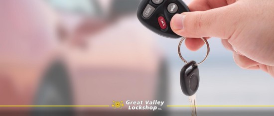 car owner holds a remote car key with a microchip