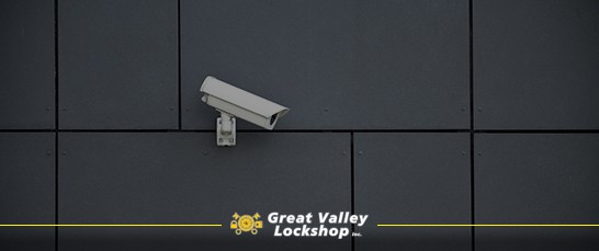 A security camera installed outside a business records video.