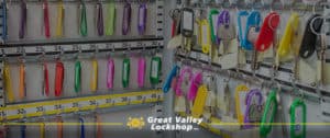 Many keys with colorful tabs hanging in a key management storage cabinet.