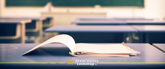 school book open on a desk in an empty classroom