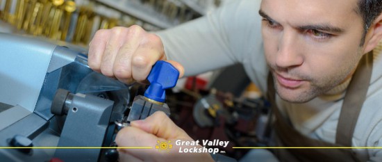 a locksmith uses a machine to cut a key