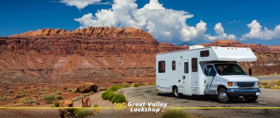 motorhome driving on the street with red rock mountains in the background