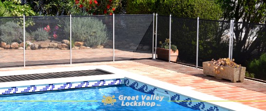 backyard pool surrounded by safety fence
