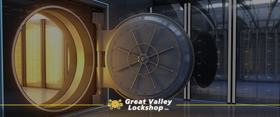 Heavy armored safe door open with gold inside a secure vault.