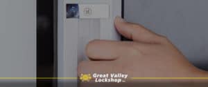 Hand of homeowner opening a sliding glass door.