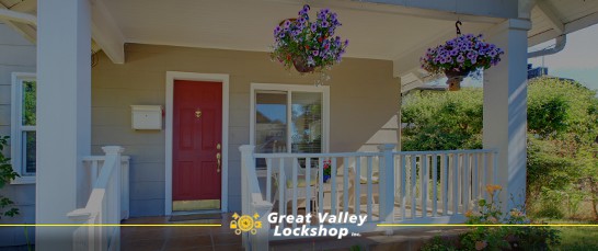 The outside of a house with a red front door.