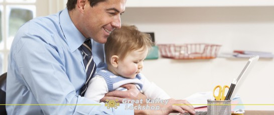 employee holding his child works from home